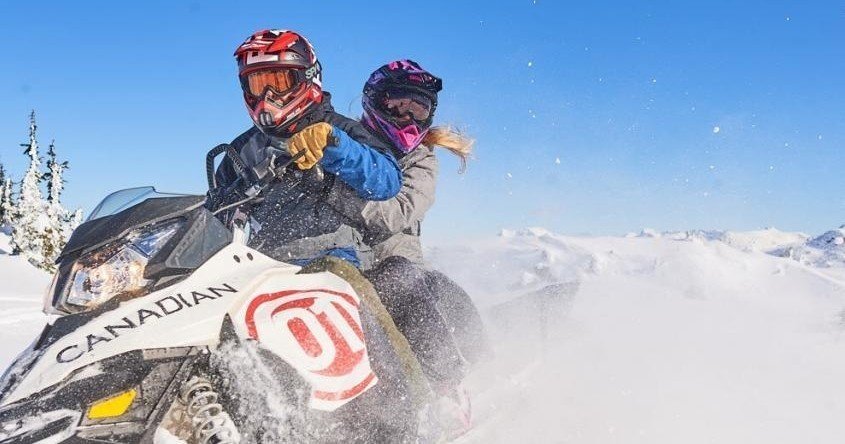 Guided snowmobile tour on a snow-covered Whistler trail